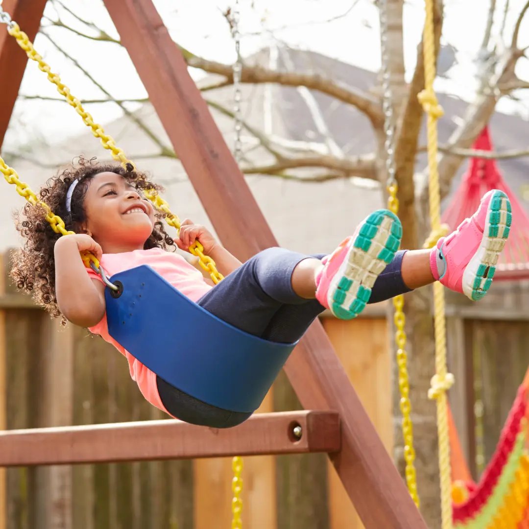 Child swinging in playground