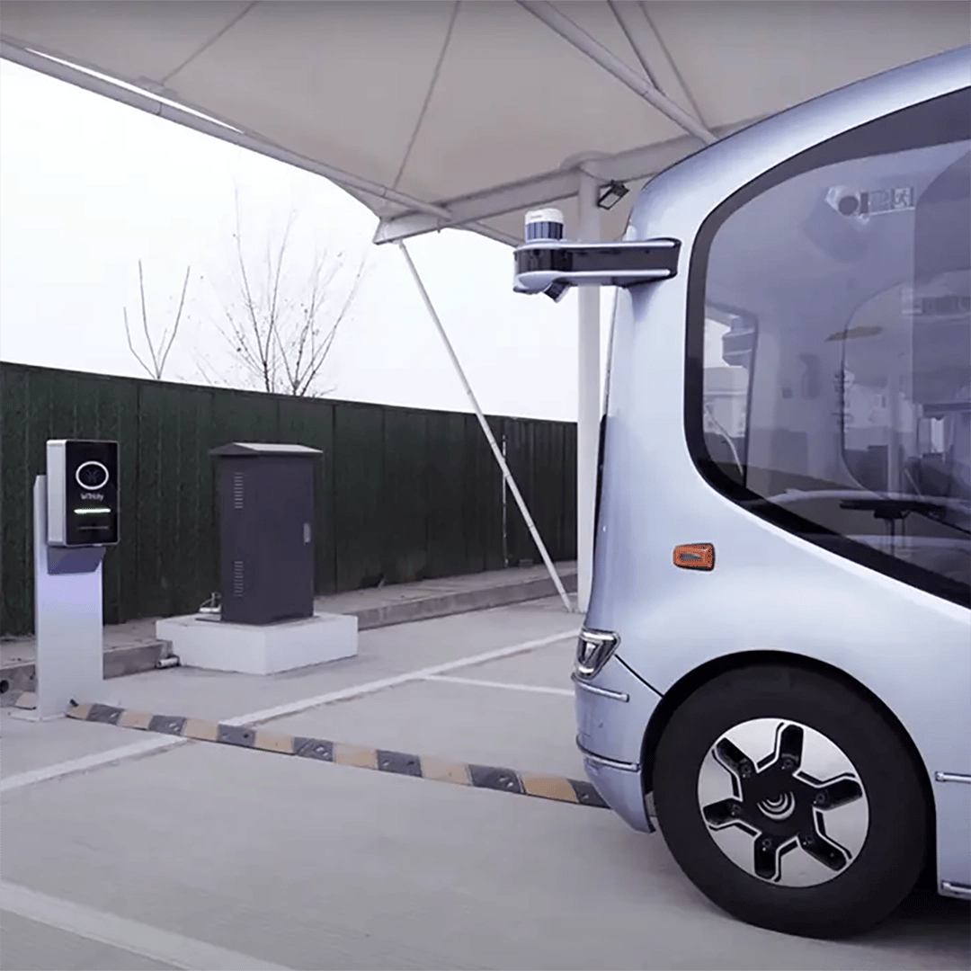 YuTong autonomous bus drives up to wireless charging pad in bus depot
