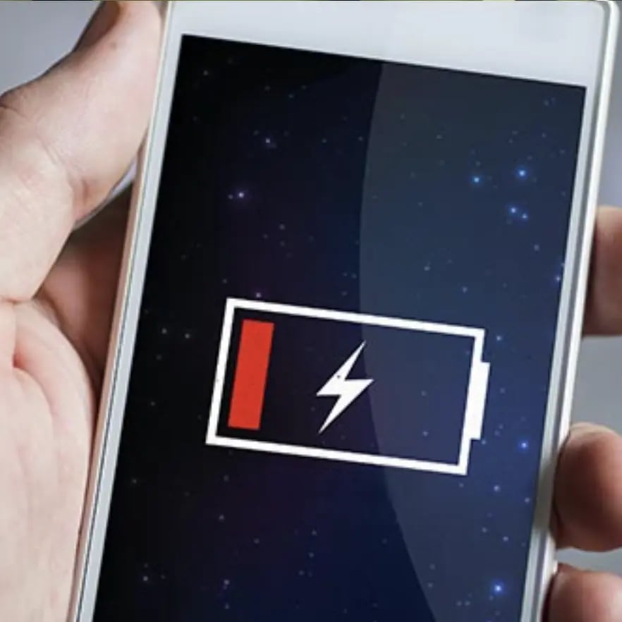 Close-up of a mobile phone showing low battery