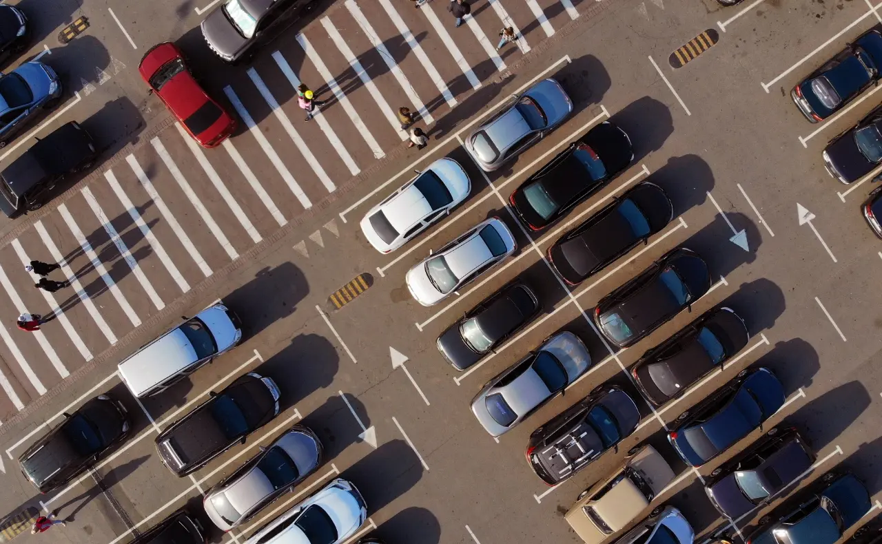 Aerial view of a commercial parking lot with vehicles parked