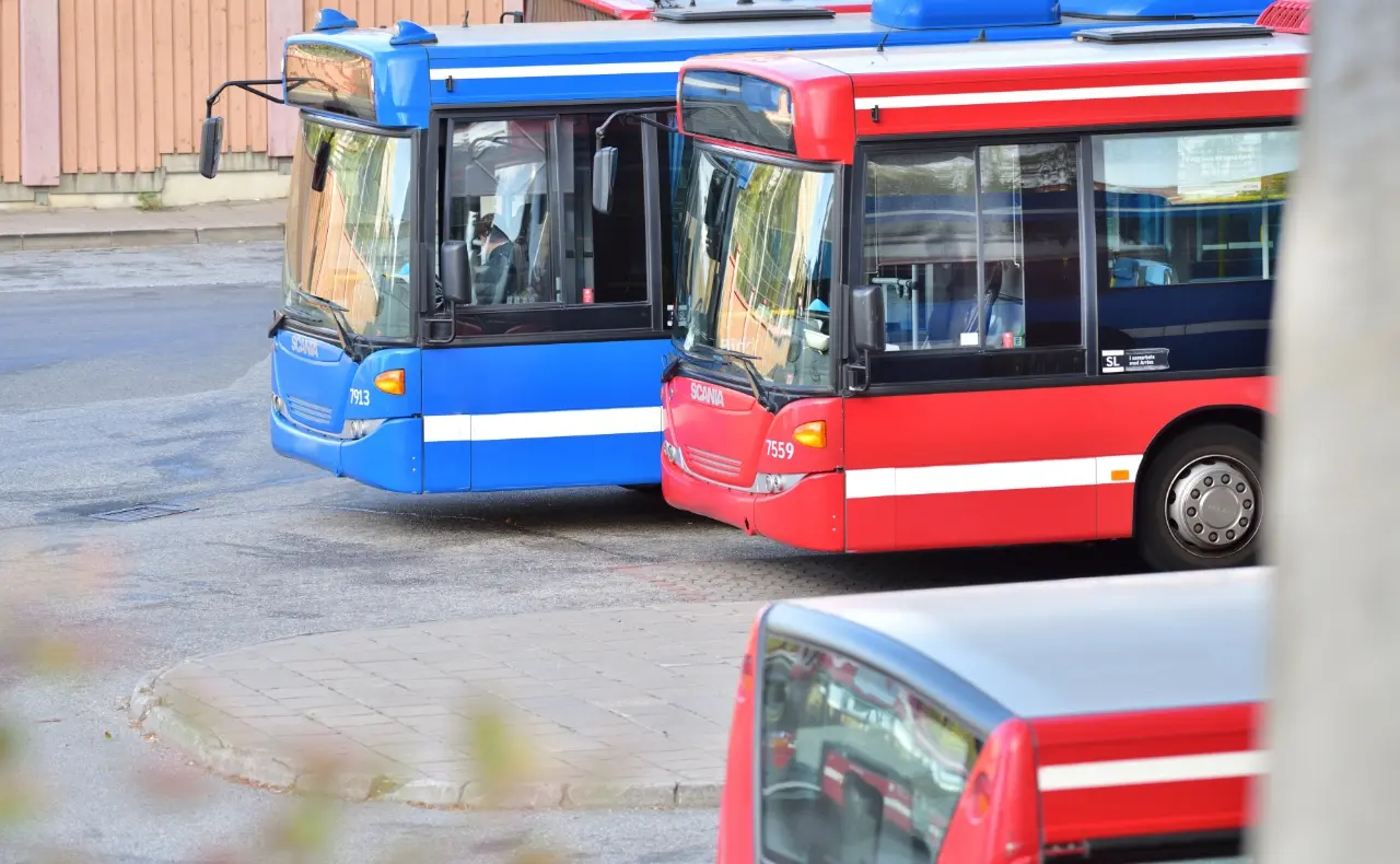 Public transportation buses parked in a depot